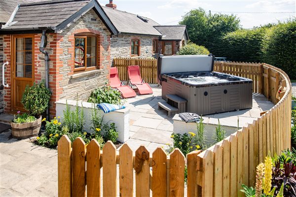 The Barn exterior showing the private hot tub and patio